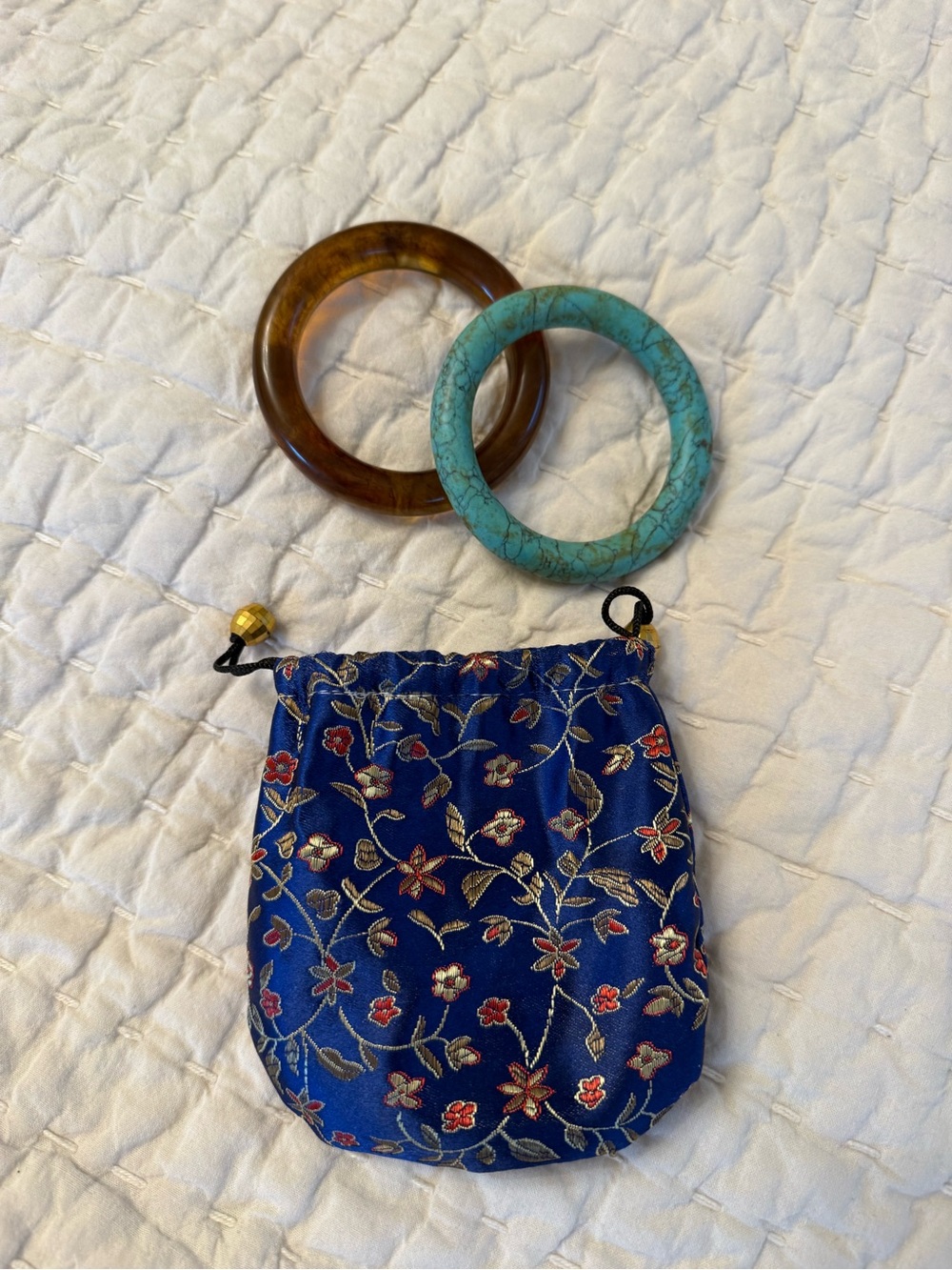 Blue Floral Drawstring Jewelry Pouch with Brown and Turquoise Bangles